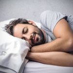 Bearded man sleeping in bed