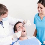 Doctor and nurse examining patient&#39;s mouth