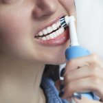 how to brush your teeth with an electric toothbrush